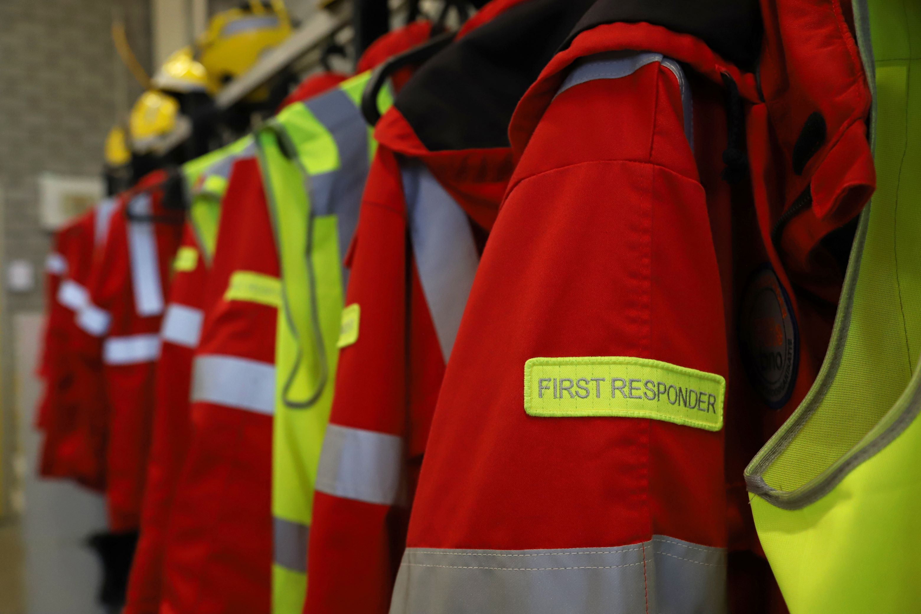 red and yellow first responder uniforms hanging up
