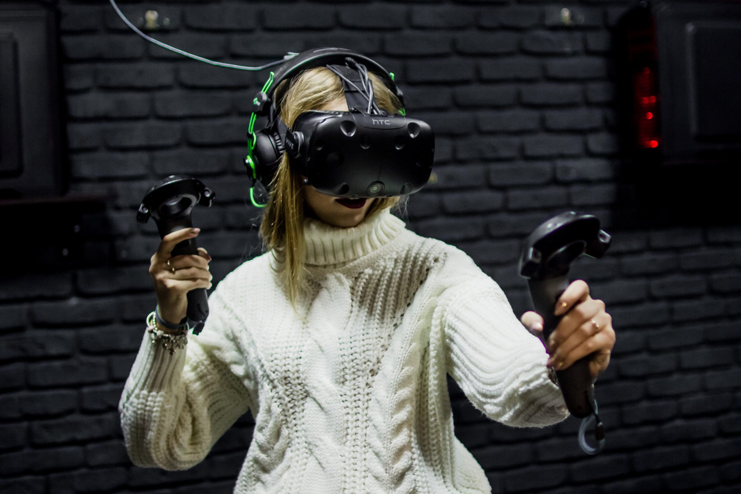 woman wearing virtual reality headset using controllers
