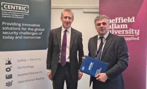 Dan Jarvis MP and Prof. Babak Akhgar OBE in front of display posters