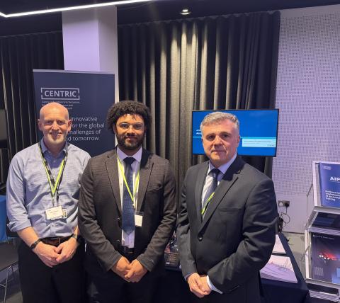 Three CENTRIC colleagues standing side by side at the launch event